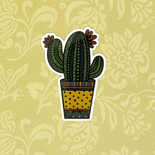 Potted cactus illustration made into a durable sticker. Laying on a light yellow background.