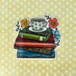 Illustrated sticker of a stack of books with a coffee cup and florals. Laying on top of a yellow background.