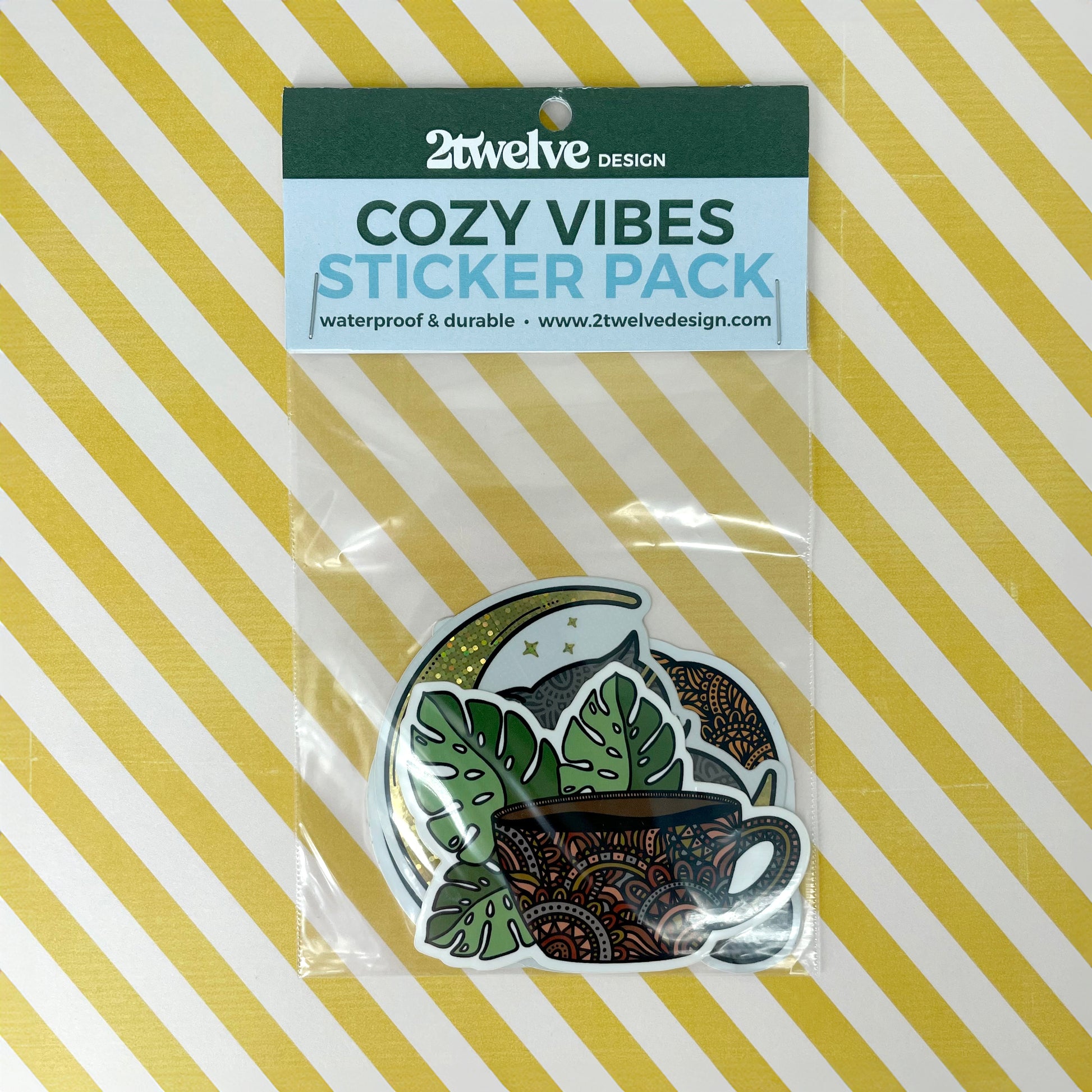 Cozy Vibes sticker pack with three stickers in clear packaging. Laying on a yellow and white background.