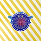 Beautiful mandala inspired dragonfly illustration made into a sticker. Laying on a white and yellow stripped background.