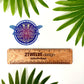 Wooden ruler with '2Twelve Design' branding and a blue and purple dragonfly illustrated sticker on a white background with green leaves.