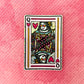 Queen of Hearts playing card sticker laying on a pink textured background