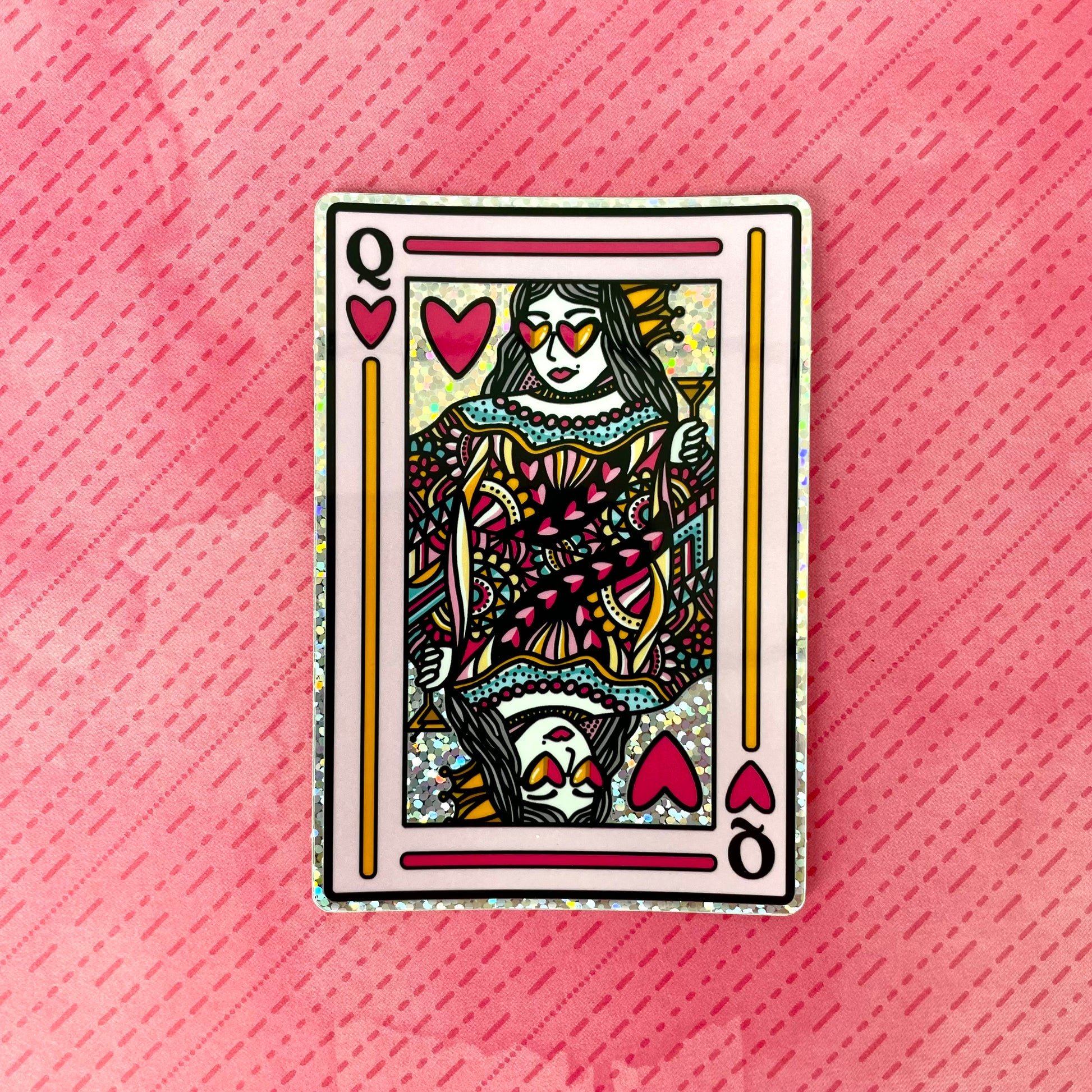 Queen of Hearts playing card sticker laying on a pink textured background