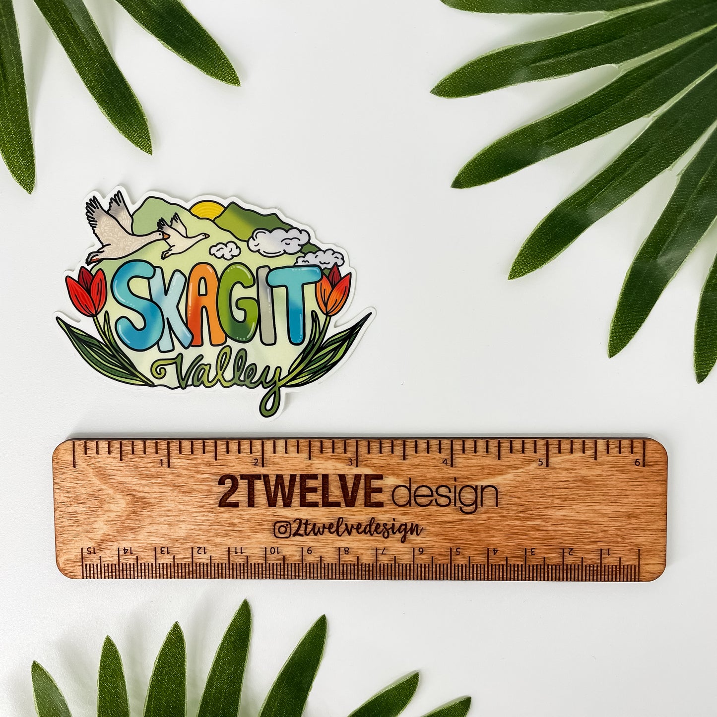 Skagit Valley, Northwest Washington sticker. Colorful with snow geese, tulips and mountains. Laying on a white background.