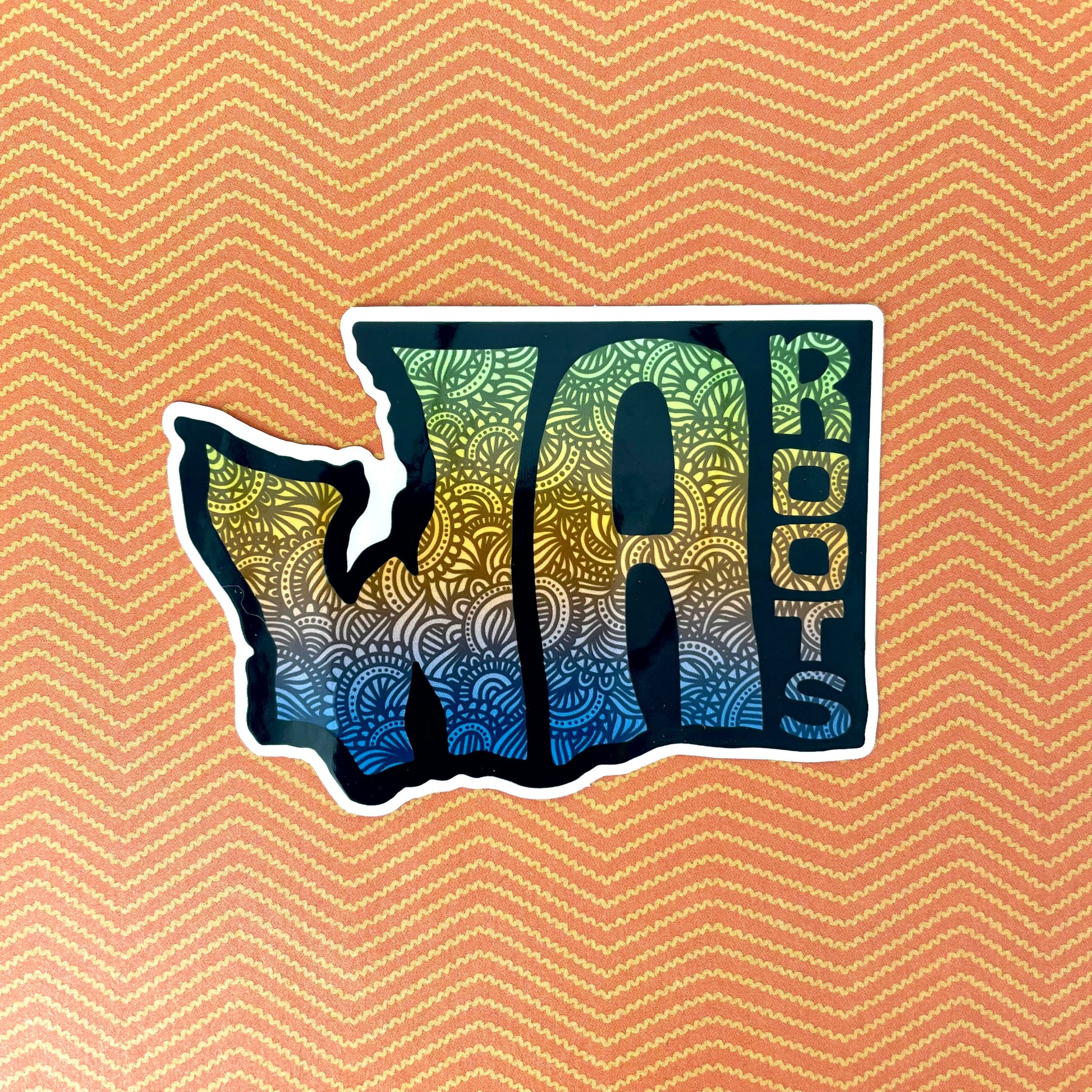 Sticker shaped like the state of Washington with 'WA Roots' text on a patterned background