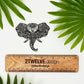 Hand-drawn black and white elephant illustration made into a sticker. Placed on a white background with a ruler that's branded "2Twelve Design", surrounded by palm leaves.