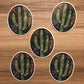 A cute cactus illustration made into an oval die-cut sticker. A group of 5 stickers laying on a wooden surface.