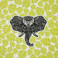 Intricate illustration of an elephant made into a vinyl sticker. Laying on a patterned tropical background.