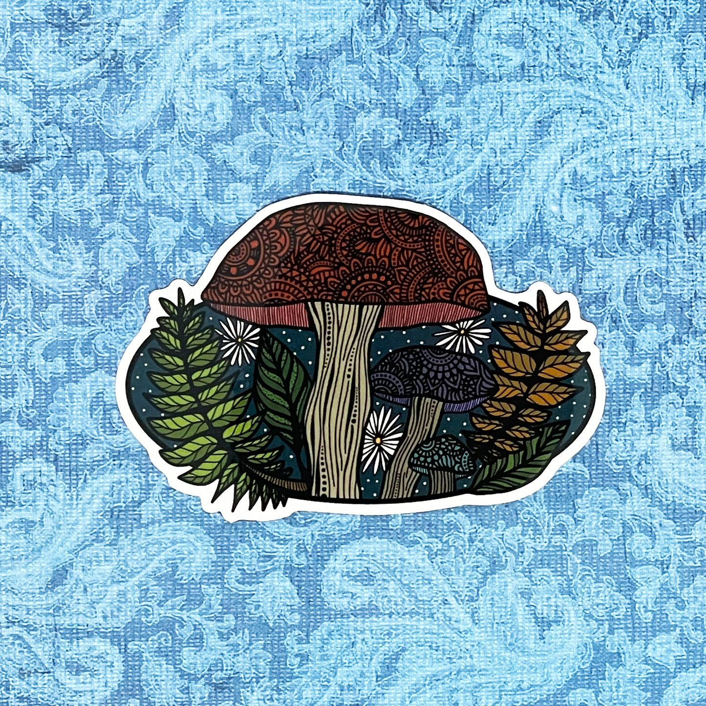A detailed mushroom, wildlife illustration made into a die-cut sticker. Laying on a blue textured background.