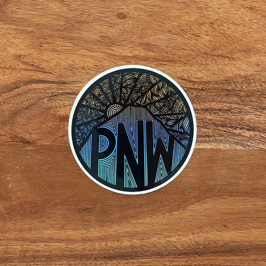 A die-cut vinyl sticker featuring a hand-drawn illustration of a Pacific Northwest mountain range at dusk. With PNW in the mountainside.