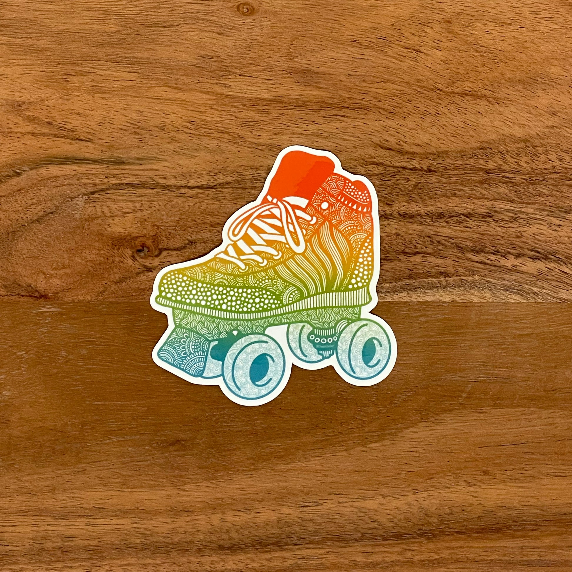 A roller skate illustration made into a die-cut sticker. Laying on a wooden surface.