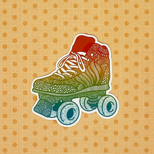 A rainbow illustrated roller skate sticker laying on a patterned orange background.