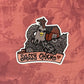 A cute chicken and barn illustration with a banner that reads "Sassy Chick", made into a vinyl sticker. Laying on a red texture background.