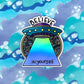A fun holographic spaceship sticker that says to believe in yourself! Purple and blue intricate illustrated patterns. Laying flat on a blue and purple background.