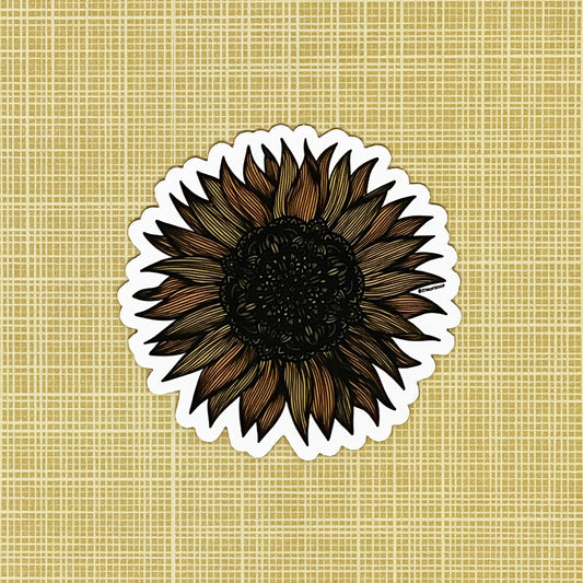 A very detailed sunflower illustration made into a die-cut matte sticker. Laying on a patterned yellow background.