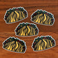 A group of five taco stickers laying on a wood surface