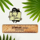 A sticker of a hand drawn sloth holding a sign that says "Take It Slow" 