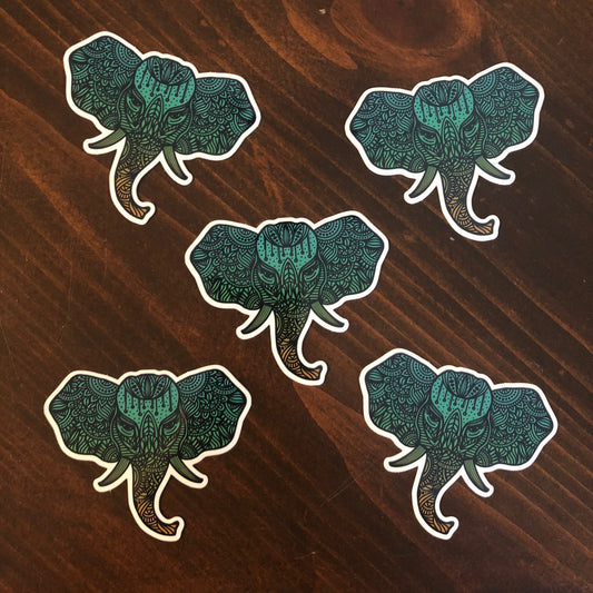 A group of five, detailed illustrated elephant stickers laying on a wooden surface